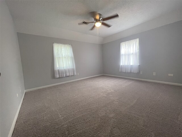 spare room featuring carpet, ceiling fan, and a textured ceiling