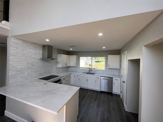 kitchen featuring dishwasher, white cabinetry, wall chimney range hood, and sink