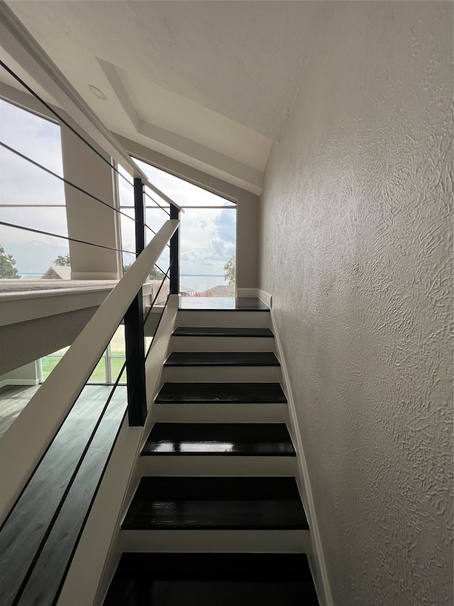 staircase featuring vaulted ceiling