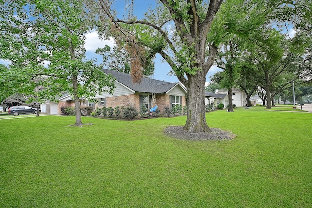 view of front of property with a front lawn and a garage