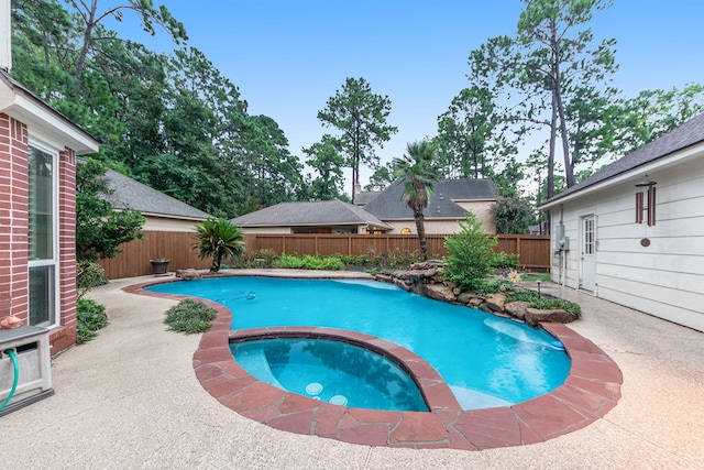 view of pool with a patio and an in ground hot tub