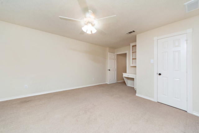 unfurnished bedroom featuring ceiling fan and light colored carpet