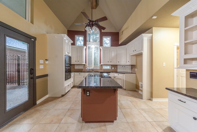 kitchen with high vaulted ceiling, white cabinets, a kitchen island, black appliances, and ceiling fan