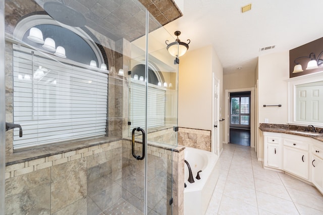 bathroom with independent shower and bath, vanity, and tile patterned floors