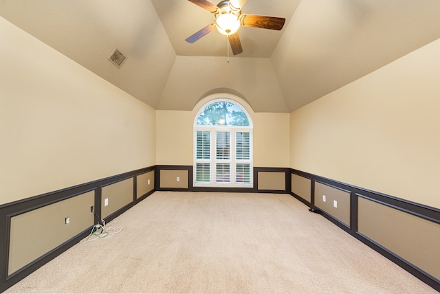 unfurnished room featuring ceiling fan, light colored carpet, and lofted ceiling