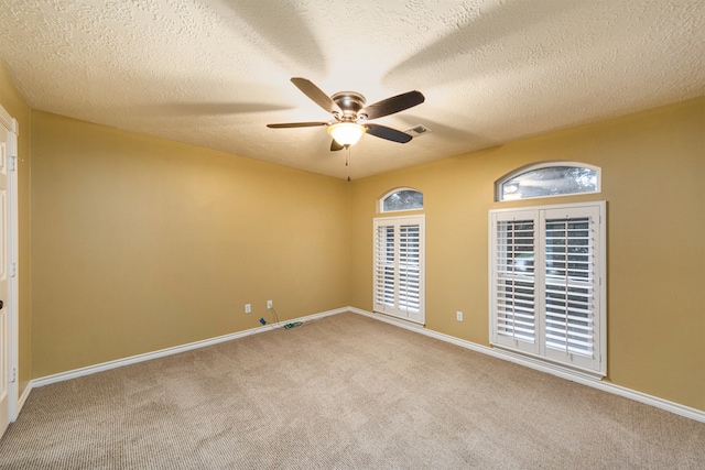 unfurnished room featuring ceiling fan, a textured ceiling, and carpet flooring