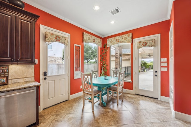 dining room with ornamental molding and light tile patterned floors