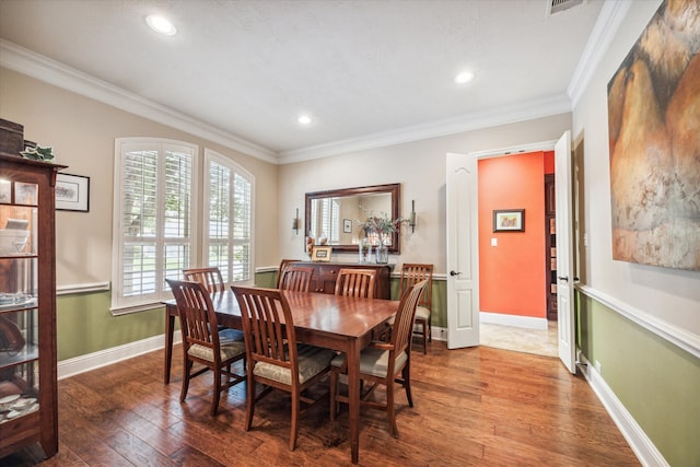 dining space featuring ornamental molding and hardwood / wood-style floors