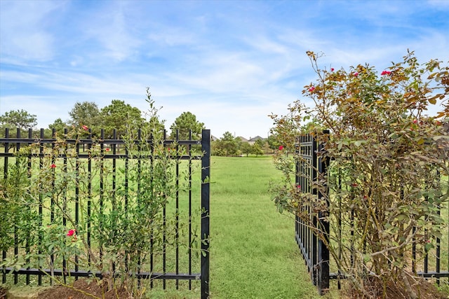 view of gate featuring a lawn