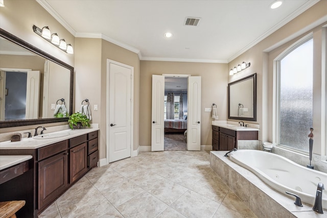 bathroom featuring crown molding, tiled tub, vanity, and tile patterned flooring