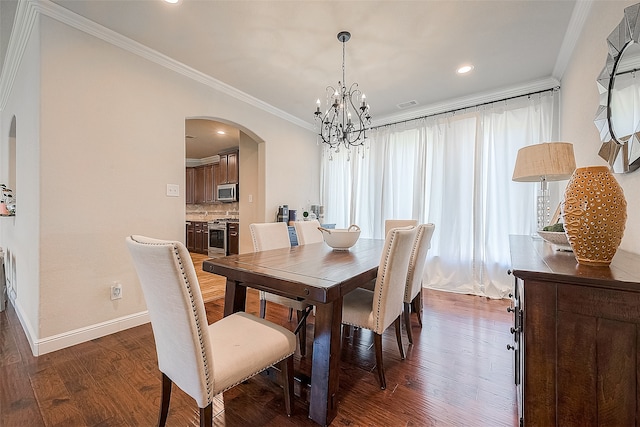 dining space with crown molding, an inviting chandelier, and dark wood-type flooring