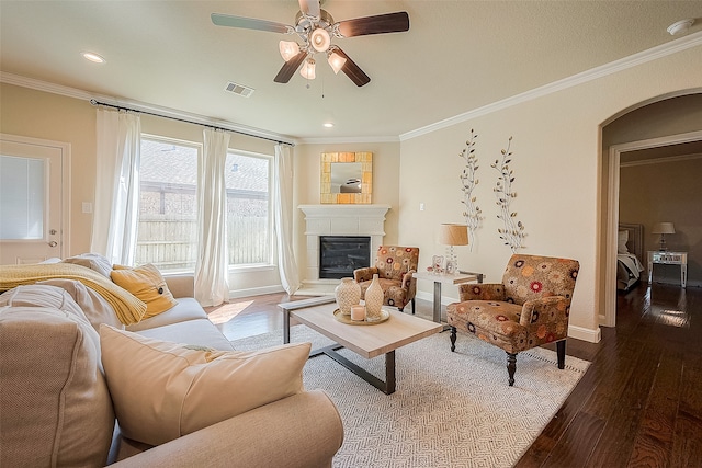 living room with crown molding, hardwood / wood-style floors, and ceiling fan