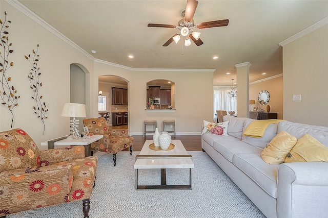 living room featuring ceiling fan, hardwood / wood-style flooring, and crown molding