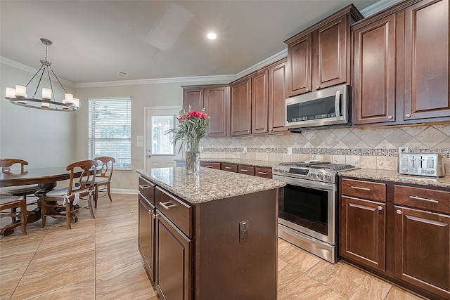 kitchen with a chandelier, dark brown cabinetry, appliances with stainless steel finishes, and a kitchen island