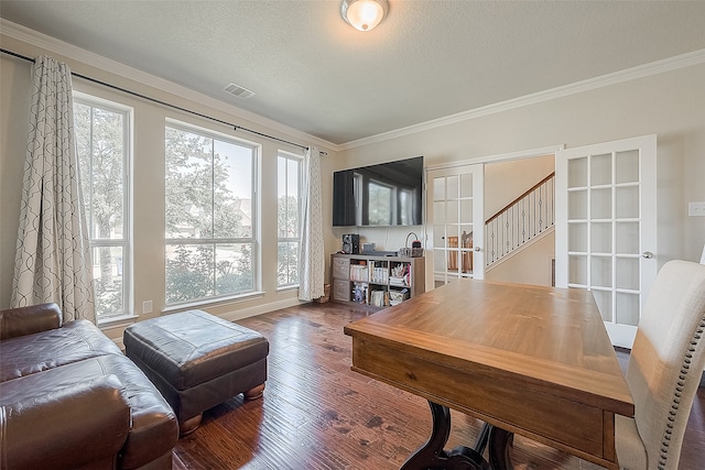 office space featuring a textured ceiling, ornamental molding, dark wood-type flooring, and french doors