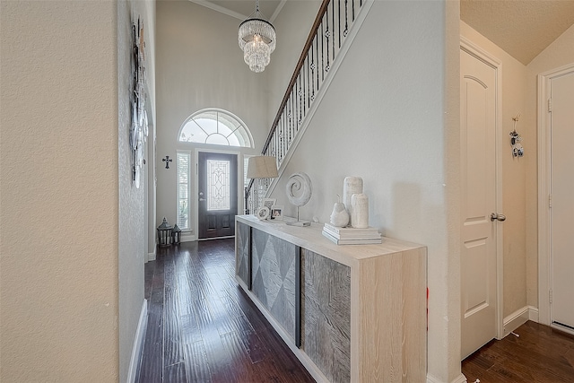 entryway with vaulted ceiling, an inviting chandelier, and dark wood-type flooring