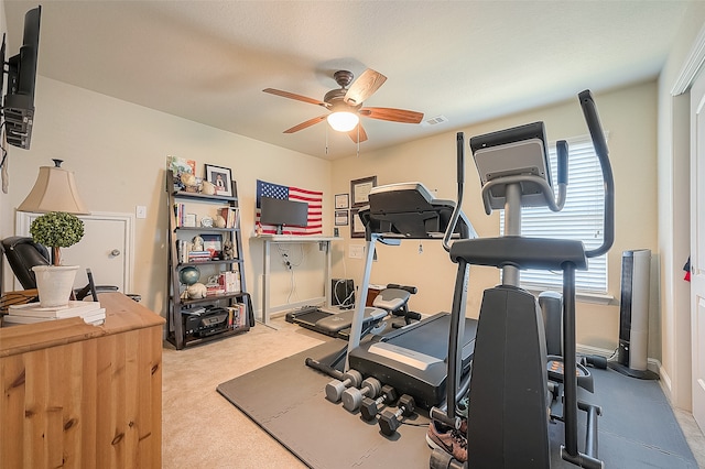 workout room with light carpet and ceiling fan