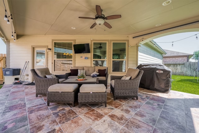 view of patio featuring area for grilling, ceiling fan, and an outdoor hangout area