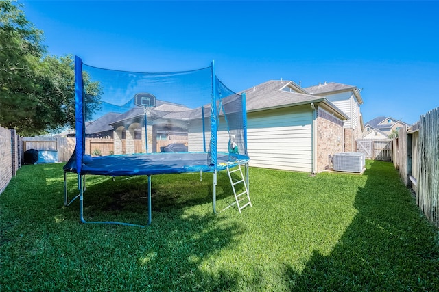 exterior space featuring a trampoline and a yard