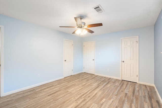 empty room featuring ceiling fan and light hardwood / wood-style flooring