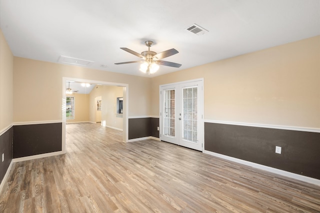 unfurnished room with light hardwood / wood-style floors, ceiling fan, and french doors