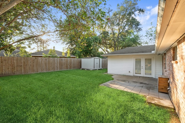 view of yard featuring french doors, a storage shed, and a patio area