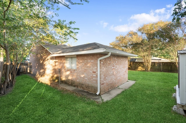 view of side of home with a lawn