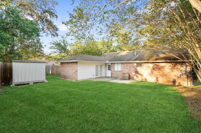 rear view of house with a storage unit, a patio, and a yard