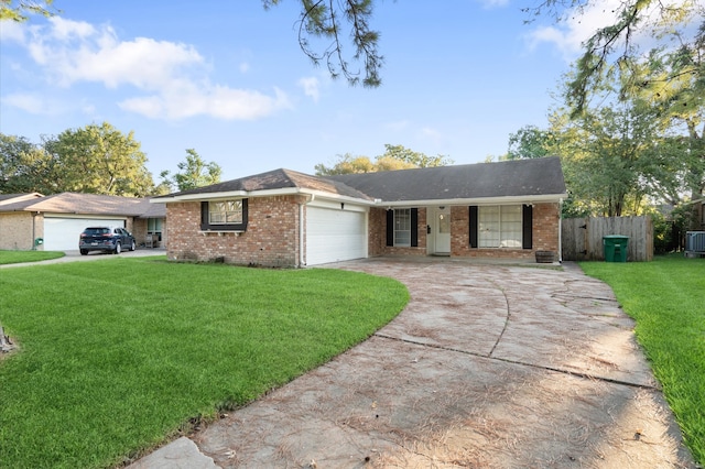 ranch-style home featuring a garage, central AC unit, and a front yard