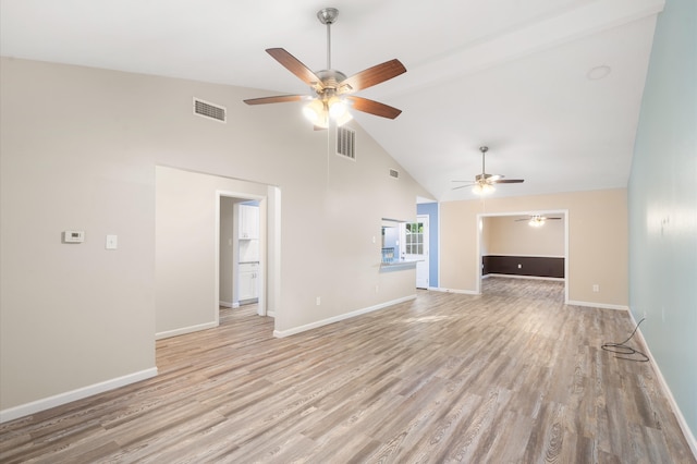 unfurnished living room featuring light hardwood / wood-style floors, ceiling fan, and high vaulted ceiling