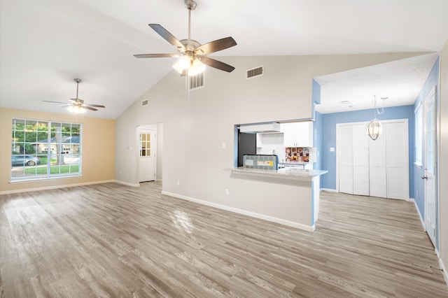 unfurnished living room featuring light hardwood / wood-style flooring, ceiling fan, and high vaulted ceiling