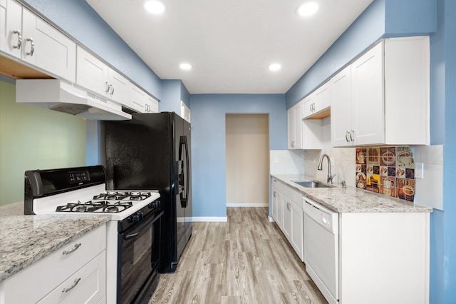 kitchen with white appliances, white cabinetry, sink, and light hardwood / wood-style flooring