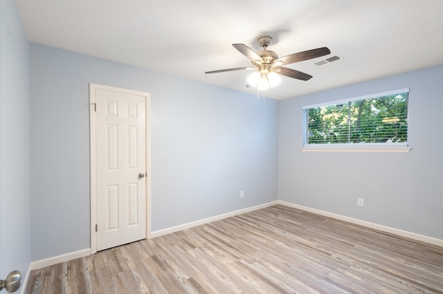 unfurnished room featuring light wood-type flooring and ceiling fan