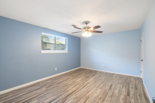 spare room featuring ceiling fan and light wood-type flooring