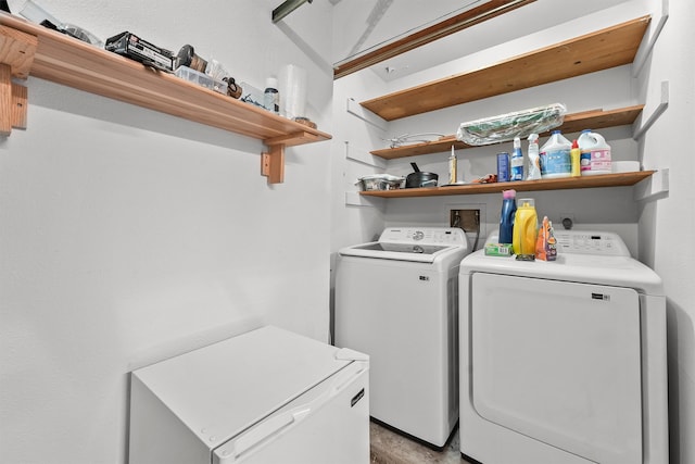 laundry area with light hardwood / wood-style floors and independent washer and dryer