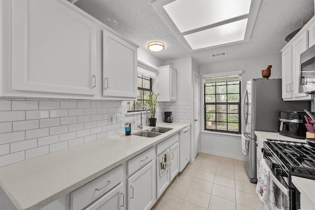 kitchen featuring white cabinetry and a healthy amount of sunlight