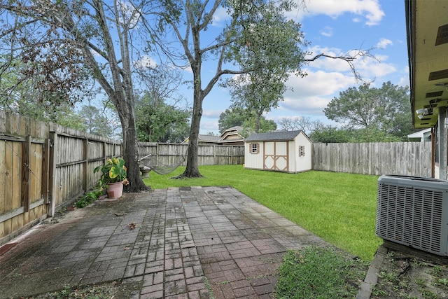 view of yard with a storage shed, central AC unit, and a patio area