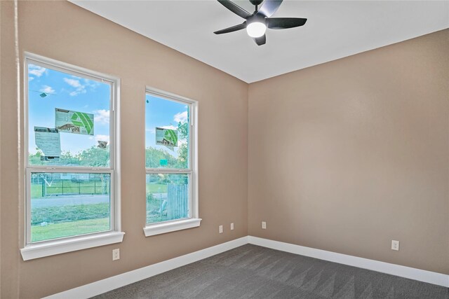 725 A Ave, La Marque, TX 77568 - spare room featuring dark carpet, baseboards, and ceiling fan