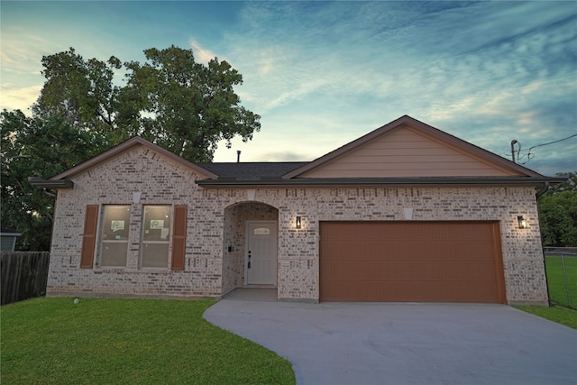 ranch-style home with a lawn and a garage