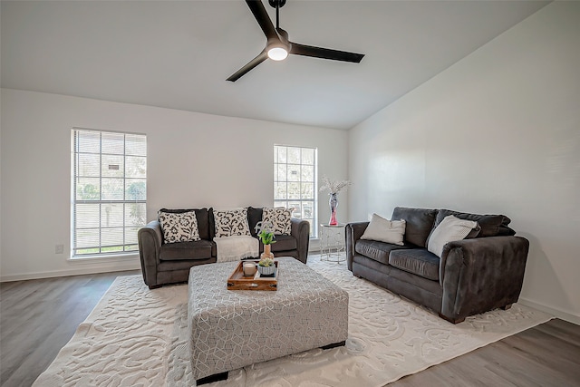 living room with vaulted ceiling, ceiling fan, and light hardwood / wood-style flooring