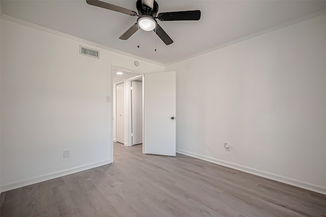 spare room with crown molding, ceiling fan, and light hardwood / wood-style flooring