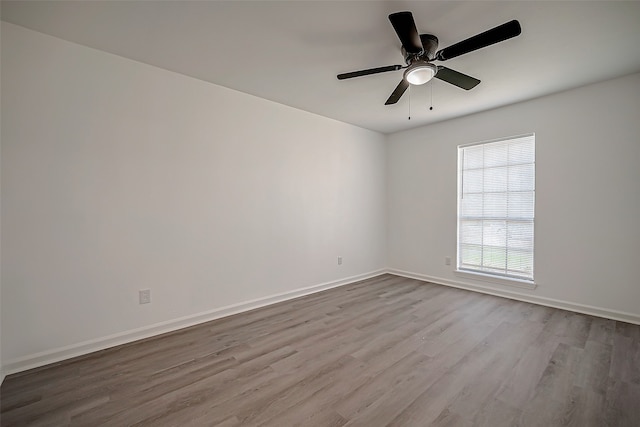 empty room featuring ceiling fan and light hardwood / wood-style flooring