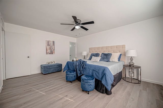 bedroom with light hardwood / wood-style floors and ceiling fan