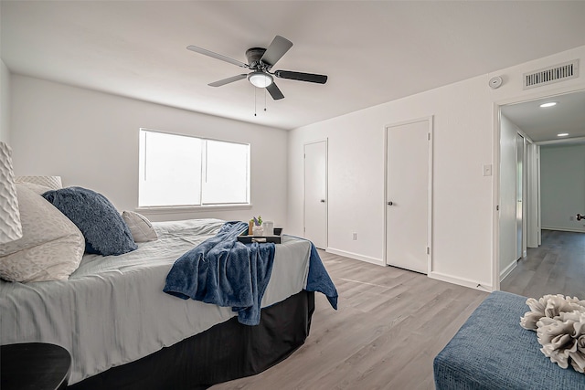 bedroom with light wood-type flooring and ceiling fan