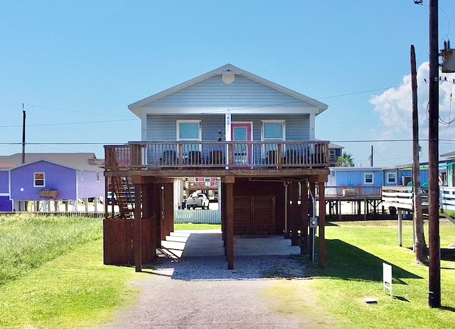 coastal inspired home featuring a carport and a front yard