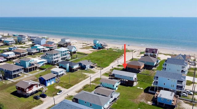 drone / aerial view featuring a water view and a view of the beach