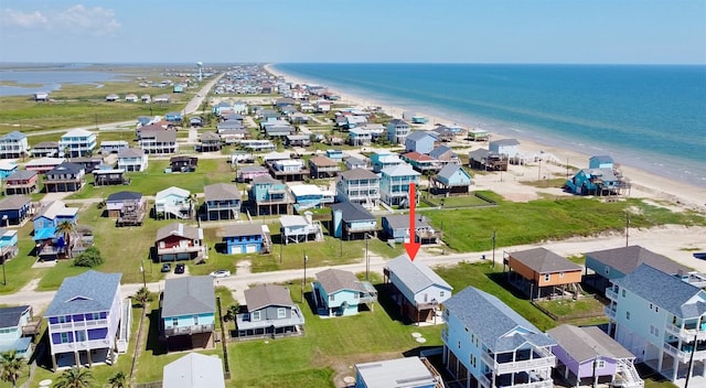 birds eye view of property with a water view and a view of the beach