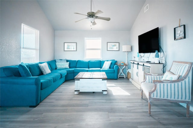 living room featuring lofted ceiling, light hardwood / wood-style flooring, and ceiling fan