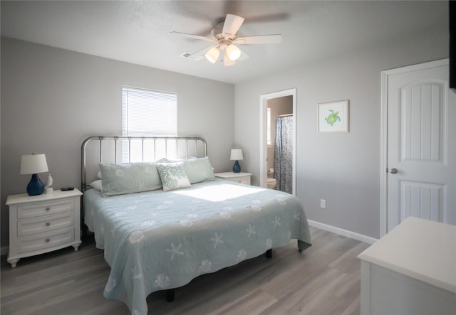 bedroom with wood-type flooring, connected bathroom, and ceiling fan