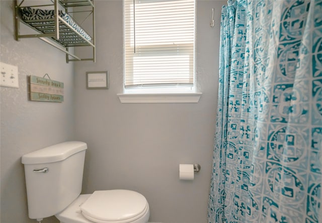 bathroom with walk in shower and toilet